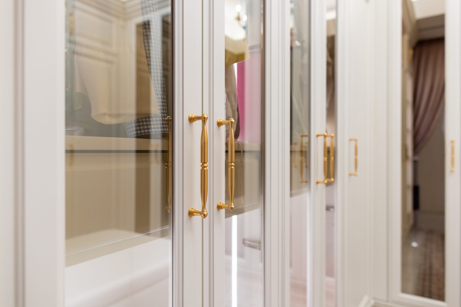 Detail of gilt bronze pulls on mirrored wardrobe doors