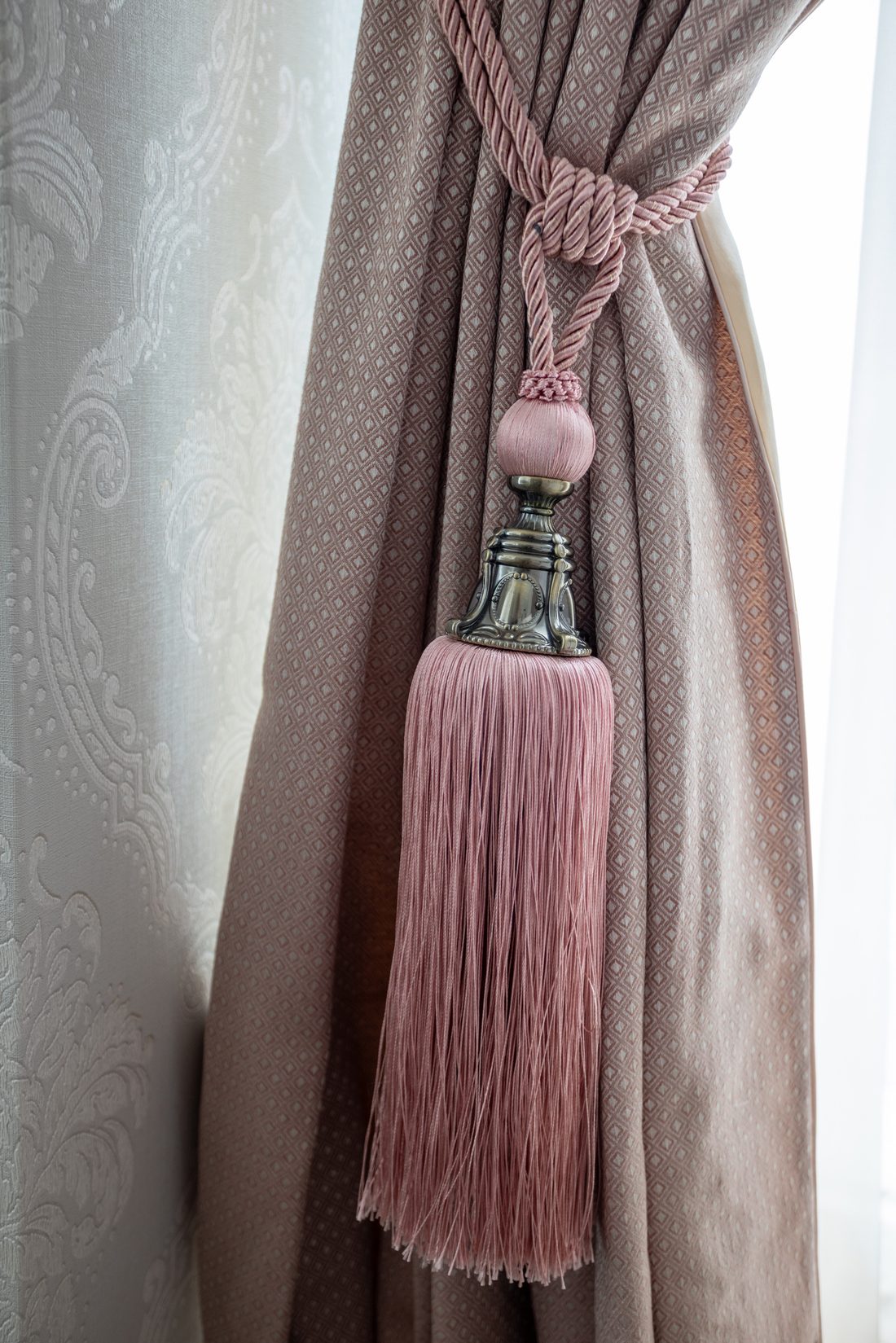Detail of a heavy silk tieback with crystal finial and beaded trim in the children's bedroom