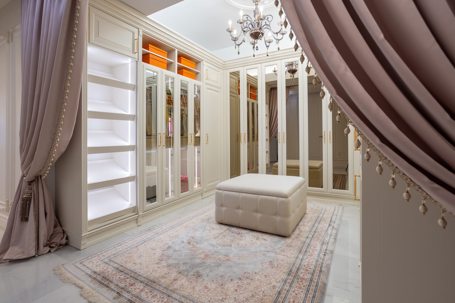 Dressing room with crystal chandelier, mirrored wardrobe doors and custom drapery