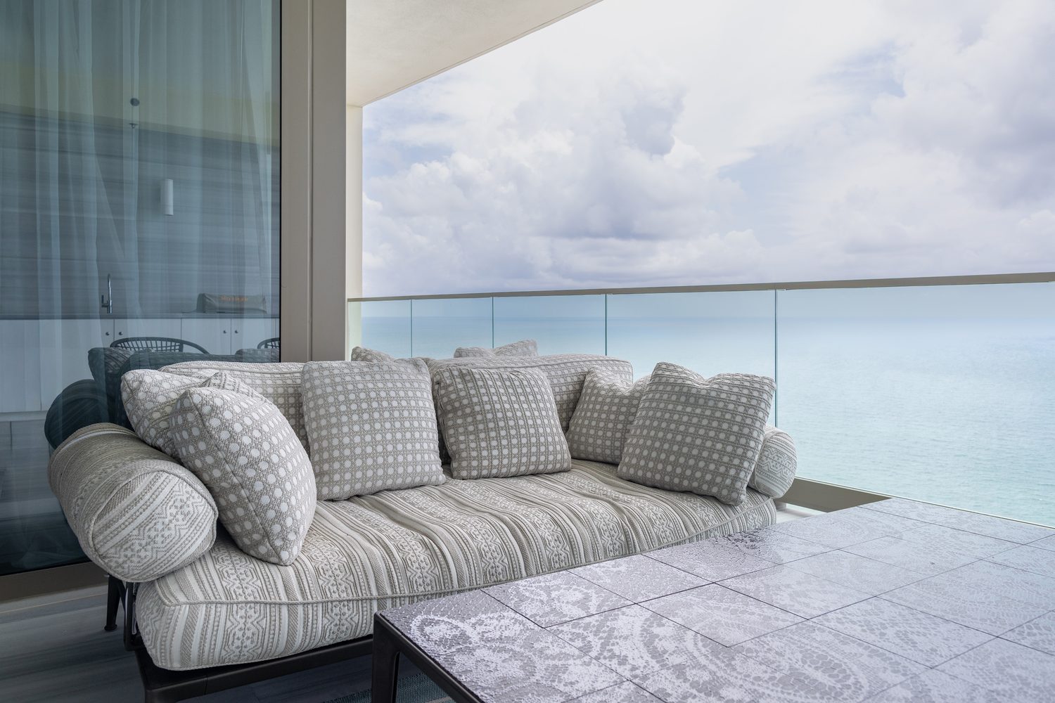 Oceanfront terrace with woven outdoor sofa overlooking the Atlantic